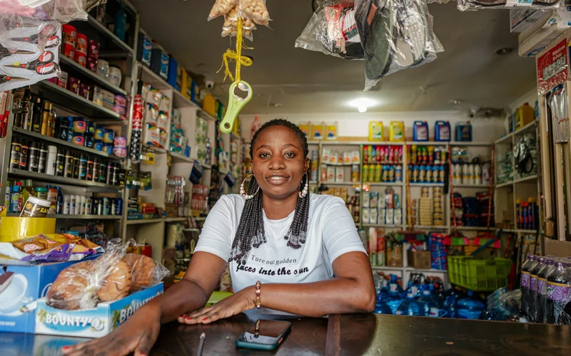 Woman behind the counter of a small neighborhood shop.